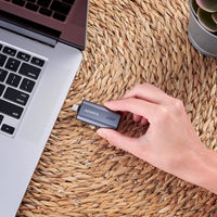 1TB ADATA SC750 USB-C Portable SSD in black titanium, compatible with various devices, showcasing USB 3.2 Gen 2 design.